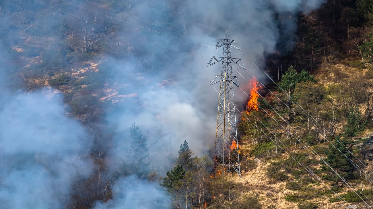 Wildfire smoke near a transmission tower