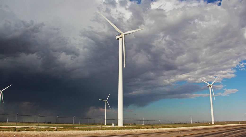 Wind turbines under storm clouds